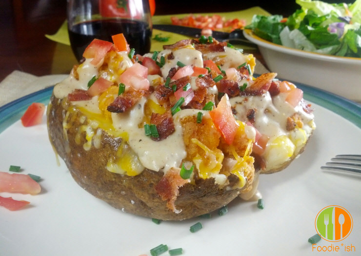 The ultimate loaded baked potato: stuffed with fried chicken, and topped with cheese and white gravy, and then finished with bacon and tomatoes. OMG. It's killer!